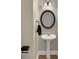 Powder room with pedestal sink and decorative mirror at 1050 Sunny Field Ct, Lawrenceville, GA 30043