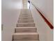 Carpeted staircase with wooden handrail at 1050 Sunny Field Ct, Lawrenceville, GA 30043