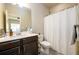 Well-lit bathroom featuring a vanity with dark wood cabinets and a shower at 1560 Baygreen Rd, Suwanee, GA 30024
