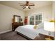Cozy bedroom with ceiling fan, natural light, and neutral decor at 1560 Baygreen Rd, Suwanee, GA 30024