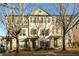 Charming brick townhome with symmetrical design, complemented by mature trees and professional landscaping at 1560 Baygreen Rd, Suwanee, GA 30024