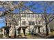 Beautiful brick townhome exterior with blooming trees in a well-maintained community at 1560 Baygreen Rd, Suwanee, GA 30024