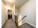 Hallway with stairway, laundry room, carpet flooring and neutral paint at 1560 Baygreen Rd, Suwanee, GA 30024