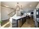 Modern kitchen with a large island featuring stainless steel appliances and an open floorplan at 1560 Baygreen Rd, Suwanee, GA 30024