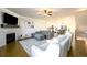 Open-concept layout with a fireplace, TV, comfortable furniture, and views into kitchen and dining at 1560 Baygreen Rd, Suwanee, GA 30024