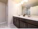 Main bathroom with double sink vanity, granite countertops, and glass enclosed shower at 1560 Baygreen Rd, Suwanee, GA 30024