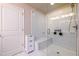 White tiled walk-in shower with glass door and seat in main bathroom at 1560 Baygreen Rd, Suwanee, GA 30024
