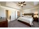 Bright and spacious main bedroom featuring a ceiling fan, and ensuite bathroom entrance at 1560 Baygreen Rd, Suwanee, GA 30024