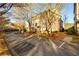 Scenic view of tree-lined street with attractive multi-story townhouses at 1560 Baygreen Rd, Suwanee, GA 30024