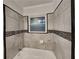 Well-maintained bathroom featuring ceramic tile, shower head, and mosaic accents at 1735 W Austin Rd, Decatur, GA 30032