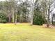Expansive backyard featuring lush green grass and mature trees, offering privacy at 3503 Saddlebrook Dr, Loganville, GA 30052
