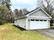 Exterior view of a home featuring a two-car garage and well-manicured lawn at 3503 Saddlebrook Dr, Loganville, GA 30052