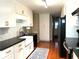 Modern kitchen featuring white cabinets, black countertop, and stainless steel appliances at 3503 Saddlebrook Dr, Loganville, GA 30052
