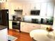 Bright kitchen with modern appliances, granite countertops, and white cabinetry at 3503 Saddlebrook Dr, Loganville, GA 30052