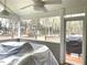 Inviting screened porch perfect for outdoor relaxation, featuring a ceiling fan and backyard view at 3503 Saddlebrook Dr, Loganville, GA 30052
