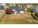 Aerial view of a fenced backyard with a patio, grilling area, seating, and a mature shade tree at 5330 Maltdie Ct, Sugar Hill, GA 30518