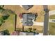 Aerial view of a fenced backyard, patio with seating, and mature trees at 5330 Maltdie Ct, Sugar Hill, GA 30518