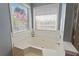Bathroom with soaking tub underneath large windows at 5330 Maltdie Ct, Sugar Hill, GA 30518