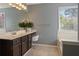 Bathroom with tiled floors and a soaking tub at 5330 Maltdie Ct, Sugar Hill, GA 30518