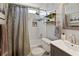 Cozy bathroom features a shower and tub combo with a rain shower head, shelves, and a single sink vanity at 5330 Maltdie Ct, Sugar Hill, GA 30518
