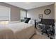 This well-lit bedroom features a window, a desk, and a comfortable bed at 5330 Maltdie Ct, Sugar Hill, GA 30518
