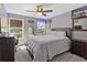 Cozy bedroom with a neutral color palette features stylish decor and plenty of natural light at 5330 Maltdie Ct, Sugar Hill, GA 30518
