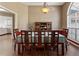 Dining area with hard wood floors, a large window, and stylish light fixture at 5330 Maltdie Ct, Sugar Hill, GA 30518