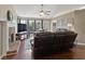 Open living room with hardwood floors, a brick fireplace, and ample seating at 5330 Maltdie Ct, Sugar Hill, GA 30518