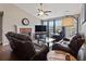 Inviting living room featuring a fireplace, large windows, and leather furniture at 5330 Maltdie Ct, Sugar Hill, GA 30518