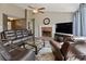 Comfortable living area with a brick fireplace, large television, and plush leather seating at 5330 Maltdie Ct, Sugar Hill, GA 30518