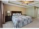 This spacious main bedroom features a ceiling fan, a tray ceiling, and neutral paint at 5330 Maltdie Ct, Sugar Hill, GA 30518