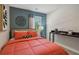 Bedroom features a red comforter, black desk, art, and large window with blinds at 5897 Mattan Trl # 67, Lithonia, GA 30058