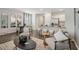 Open-concept living room with a view of the kitchen and dining area, modern furniture, and natural light at 5897 Mattan Trl # 67, Lithonia, GA 30058