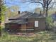 Back exterior of home with overgrown yard at 707 Dill Sw Ave, Atlanta, GA 30310