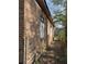 Side exterior view of brick home and overgrown yard at 707 Dill Sw Ave, Atlanta, GA 30310