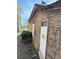 Side exterior of home with boarded up windows and overgrown foliage at 707 Dill Sw Ave, Atlanta, GA 30310
