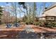 Charming backyard with a firepit, chairs, deck, and landscaped walkway at 7725 Bold Springs Xing, Cumming, GA 30041