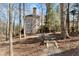 Back exterior of the house with a backyard, deck, and wooded area at 7725 Bold Springs Xing, Cumming, GA 30041