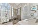 Bathroom with glass shower, double sink vanity, and arched window at 7725 Bold Springs Xing, Cumming, GA 30041