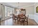 Formal dining room with hardwood floors, large window, and elegant furniture at 7725 Bold Springs Xing, Cumming, GA 30041