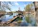 Picturesque lakeside dock featuring a boat slip and an upper deck with seating at 7725 Bold Springs Xing, Cumming, GA 30041