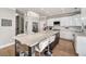 Spacious kitchen features an island with granite countertop and modern lighting at 7725 Bold Springs Xing, Cumming, GA 30041