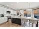 Eat-in kitchen boasts a large island, pendant lighting, and stainless steel appliances at 7725 Bold Springs Xing, Cumming, GA 30041