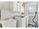 Convenient laundry room with washer, dryer, sink, and storage cabinets at 7725 Bold Springs Xing, Cumming, GA 30041