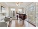 Elegant living room with hardwood floors, bright windows, and a grand piano at 7725 Bold Springs Xing, Cumming, GA 30041
