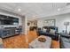 Large living area features hardwood floors, coffered ceilings and adjacent bar area at 7725 Bold Springs Xing, Cumming, GA 30041