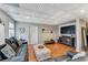 Large living area features a decorative coffered ceiling and wood laminate flooring at 7725 Bold Springs Xing, Cumming, GA 30041