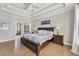 Cozy main bedroom showcases hardwood floors and a tray ceiling at 7725 Bold Springs Xing, Cumming, GA 30041