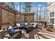 Inviting deck features comfortable seating and decorative privacy lattice at 7725 Bold Springs Xing, Cumming, GA 30041