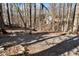 Landscaped yard with a gravel path and wooded surroundings at 7725 Bold Springs Xing, Cumming, GA 30041